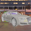 Silver Audi Car Parked In Urban City Street With Night Lights