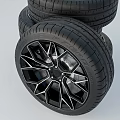 Car Tire with Black Geometric Alloy Wheel and Tread Pattern Design
