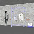 Metal Clothing Display Rack With Hanging Shirts And Astronaut Model By Concrete Wall