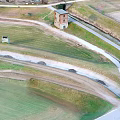 Cartoon Scene of Green Fields Winding Path and Red Brick Tower in Aerial View Grassland