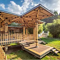 Wooden Pergola Structure Over Pond With Green Trees Grass And Blue Sky
