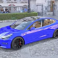 Blue Modern Sedan with Sleek Design and Black Wheels on Urban Cobblestone Street