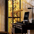 Display Cabinet With Glass Doors Showing Superhero And Robot Toy Figures On Lit Shelves
