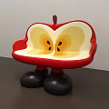 Apple Shaped Public Chair With Red Exterior Yellow Interior And Black Legs
