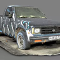 Old Worn Out Truck With Graffiti Paint And Worn Tires Parked On Dirty Ground