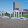 Modern White Railing Along Paved Road With Green Grass Tall Buildings And Blue Sky