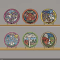 Various Handmade DIY Decorative Plates With Colorful Cartoon Patterns On Wooden Shelves
