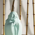 Light Green Laughing Buddha Sculpture With Clasped Hands Beads And Bamboo Background