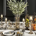 Elegant Golden Dinnerware Set With Black Placemats Candle Holders And Fruit Jars