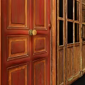 Vintage Wooden Double Doors With Glass Panels Red Patterned Wallpaper And Wooden Wainscoting