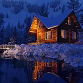 Stunning Snowy Winter Night Landscape With Warm Lit Log Cabin Beside Calm Lake In Forest