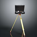 Black Electronic Device Mounted On Yellow Tripod Stand For Portable Use