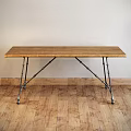 Rustic Wooden Dining Table With Metal Brackets Legs On Wooden Floor Interior