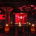 Stylish Bar Interior Design With Red Neon Lights Barrel Seats Stage And Lounge Atmosphere