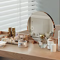 Elegant Wooden Vanity Table Displaying Perfumes And Cosmetics With Round Mirror And Various Bottles