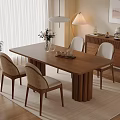 Warm Modern Dining Area With Wooden Table Wicker Chairs Cabinet And Potted Plant