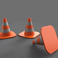 Road Infrastructure Equipment Including Orange And White Striped Traffic Cones In Standing And Fallen Positions