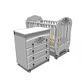 White Baby Crib With Carved Design And Matching Drawer Chest On Wheels