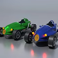 Green And Blue Vintage Race Cars With Open Cockpits Yellow Headlights And Black Tires