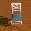 White Frame Leisure Chair With Blue Cushion And Woven Backrest On Wooden Floor