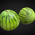Two Fresh Watermelons With Green Striped Rind On Black Background