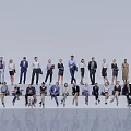 Group of People Standing and Sitting in Various Attire at Team Gathering in Professional Setting