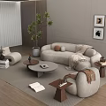 Light Colored Curved Sofa Round Coffee Table Set With Side Tables Floor Lamp Wall Art