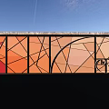 Colorful Stained Glass Feature Wall With Geometric Patterns Against Blue Sky