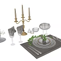 Elegant Dinnerware Set With Candelabra Wine Glasses Folded Napkins And Green Leaf Decor