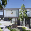 Modern Boutique Guesthouse Building With Palm Trees Greenery And Stone Pathway