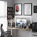 Modern Home Office Desk Setup With Monitor Keyboard Mouse Speakers Potted Plant And Framed Artwork