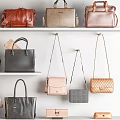 Stylish Assorted Handbags in Various Colors Displayed on White Shelves