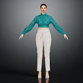 Woman in Green Lace Top and White Pants Standing Against Dark Background
