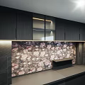 Modern Black Kitchen Interior With Cabinet Lighting And Floral Backsplash