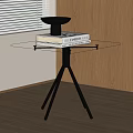 Modern Glass Top Side Table with Black Tripod Legs by Wooden Cabinet and Blinds