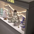 Art Cake Window Display With White Illuminated Showcase And Multi Tier Decorated Cakes
