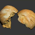 Fresh Baked Bread Two Sliced Pieces Golden Crust Soft Porous Interior on Black Surface