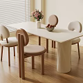 Modern White Dining Table with Four Beige Chairs and Pink Flower Vase on Wooden Floor