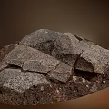 Natural Stone And Wood Pieces Piled Together With Earthy Soil In Natural Setting