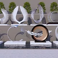 Modern Outdoor Sculptures With Circular Metal Designs Displayed On Pedestals