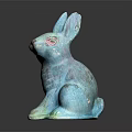 Two Turquoise Decorative Sitting Rabbit Statues on Dark Reflective Surface