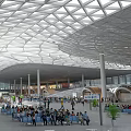 Modern Station Interior With Spacious Design Unique Grid Roof And Crowded Passengers