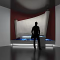 Silhouette Person Standing Near Scroll Structure In Modern Exhibition Space With Ambient Lighting