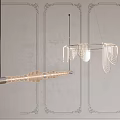 Contemporary Hanging Chandeliers With Metallic Frames And Glass Details Against Textured Decorative Walls