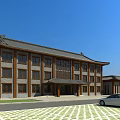 Chinese Style Office Building With Traditional Roof Brown Exterior Parking Lot Car And Blue Sky