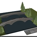 Stone Arch Bridges Spanning River With Green Trees and Grass Near Paved Walkway