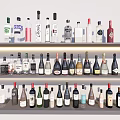 Different Types of Wine Bottles and Glasses with Various Labels on Shelves