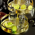 Elegant Liquor Bottles and Glasses with Lemon Slices Ice Cubes on Golden Trays
