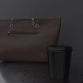 Sturdy Metal Outdoor Bench With Brown Bag Black Cup And Fallen Leaves By Gray Wall