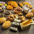 Fresh Assorted Baked Goods With Croissants Bagels Cream Pastries And Meringues On Wooden Table